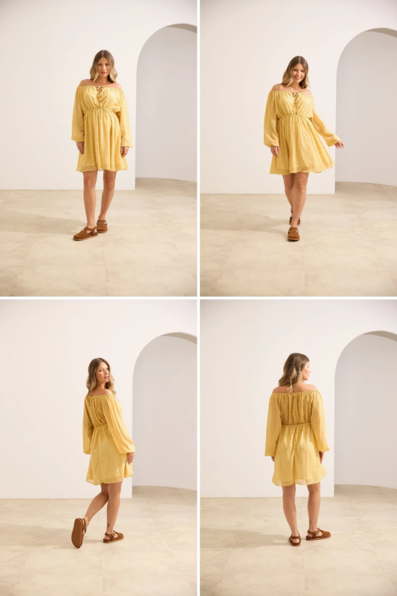 Gestante usando vestido curto amarelo fluido ombro a ombro com mangas longas e decote regulável.